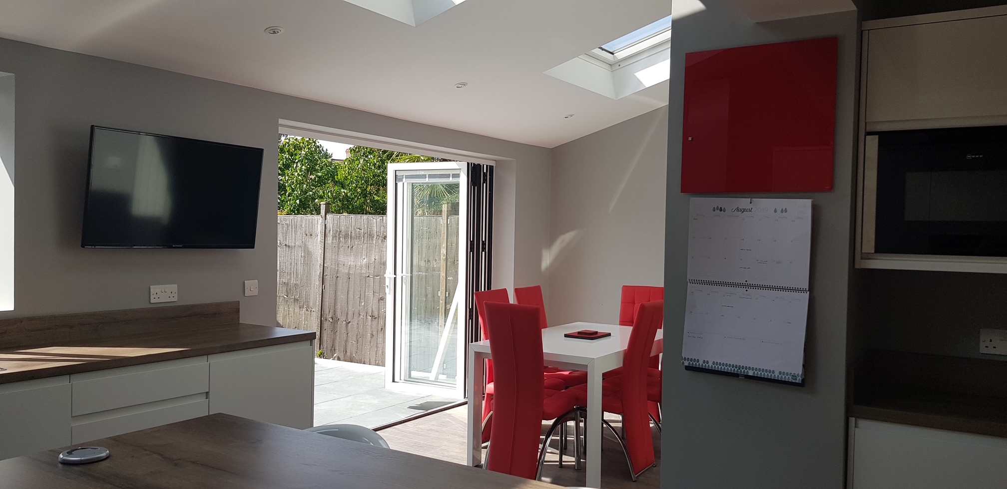 Completed extension — open-plan dining area with bifold doors and roof lantern